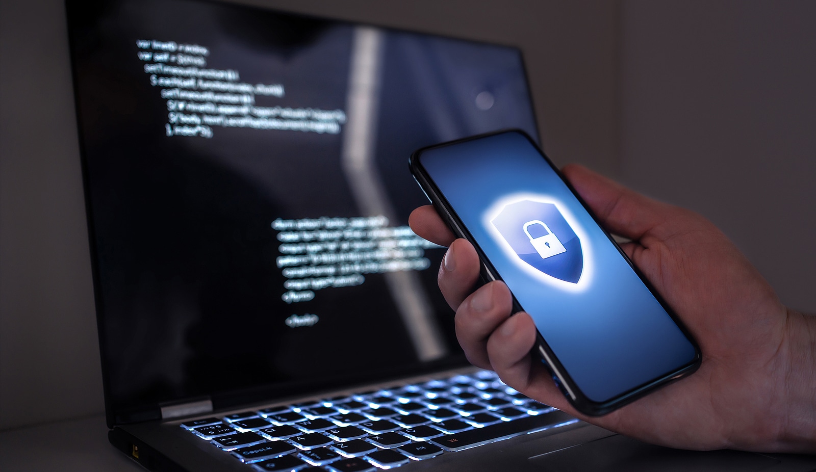 Cyber security in phone and laptop to protect from fraud, cybersecurity attack or identity theft. Electronic mobile scam, online computer data crime or email phishing concept. Code lock for privacy.